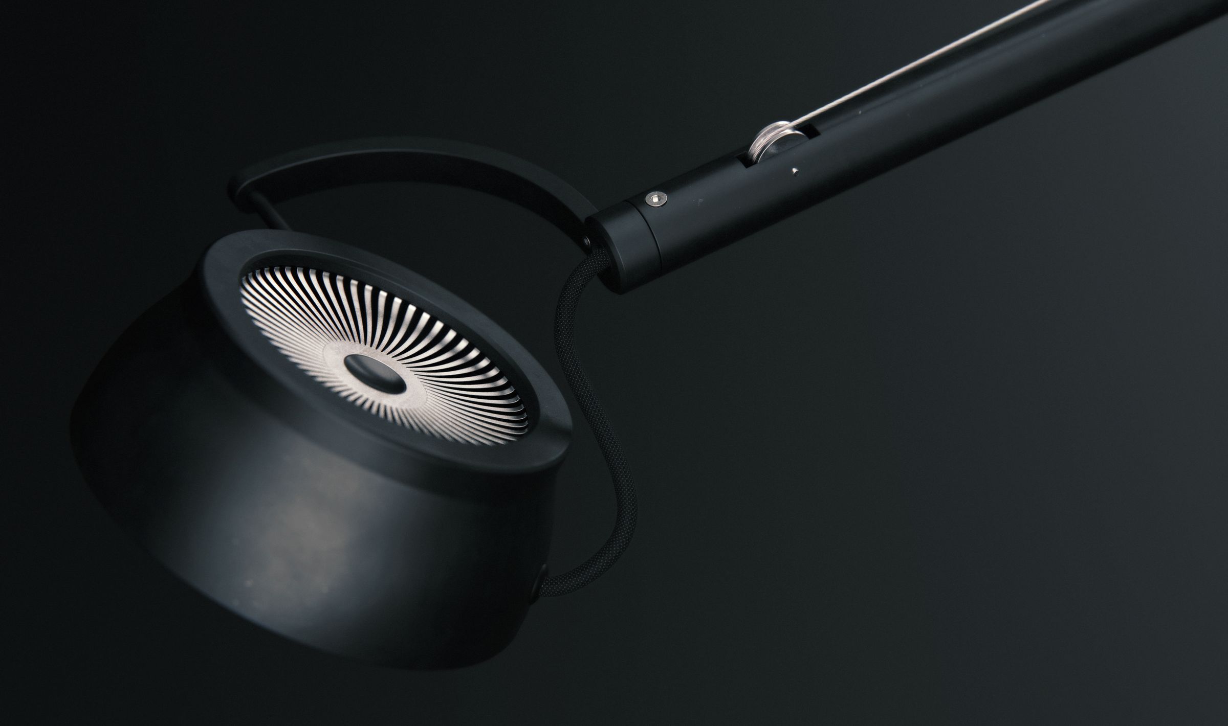 Close-up of the underside of the lamp head, showing its finned, heatsink-like vent pattern.