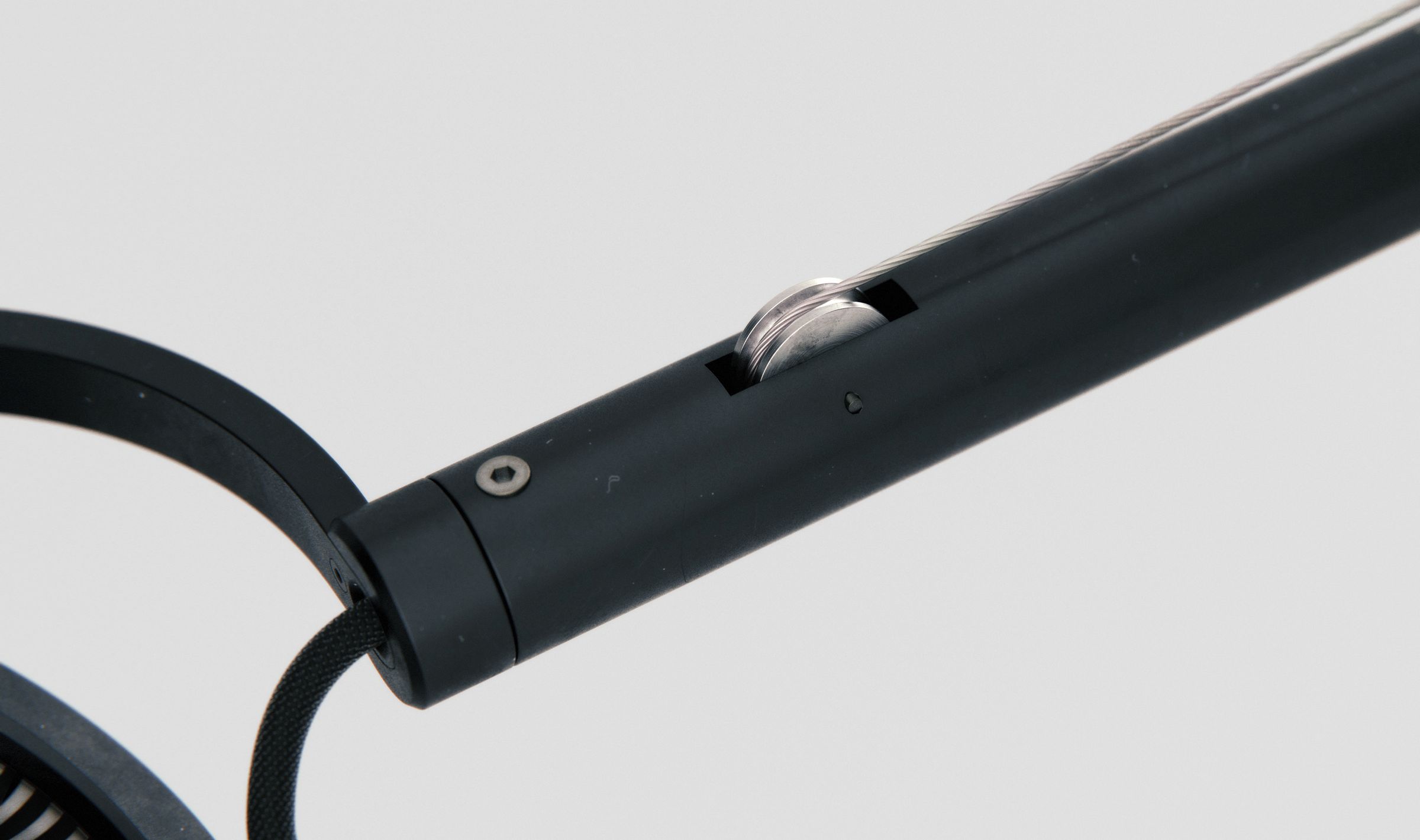 Close-up of one of the lamp's arm joints, showing a cylindrical pivot hinge with a visible bolt.