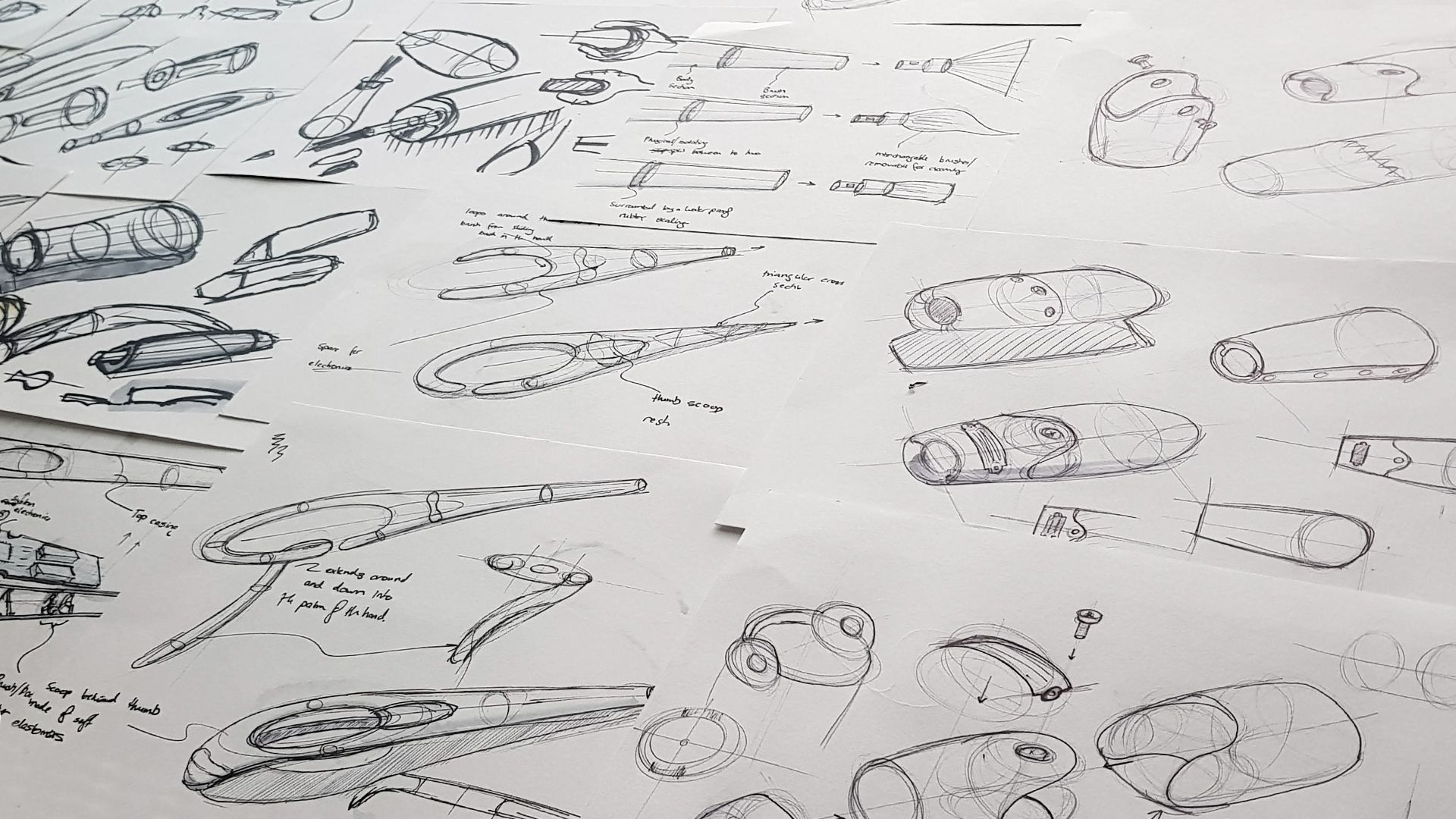 A page of pencil concept sketches exploring different handheld brush-holder forms.